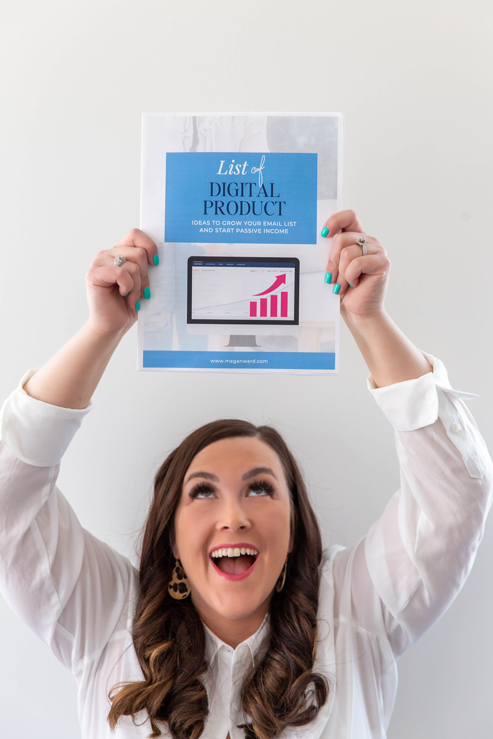 woman holding printed digital product | Wanna bring in passive income for your biz through digital products? Learn how to create a digital product in 3 easy steps! | Magan Ward