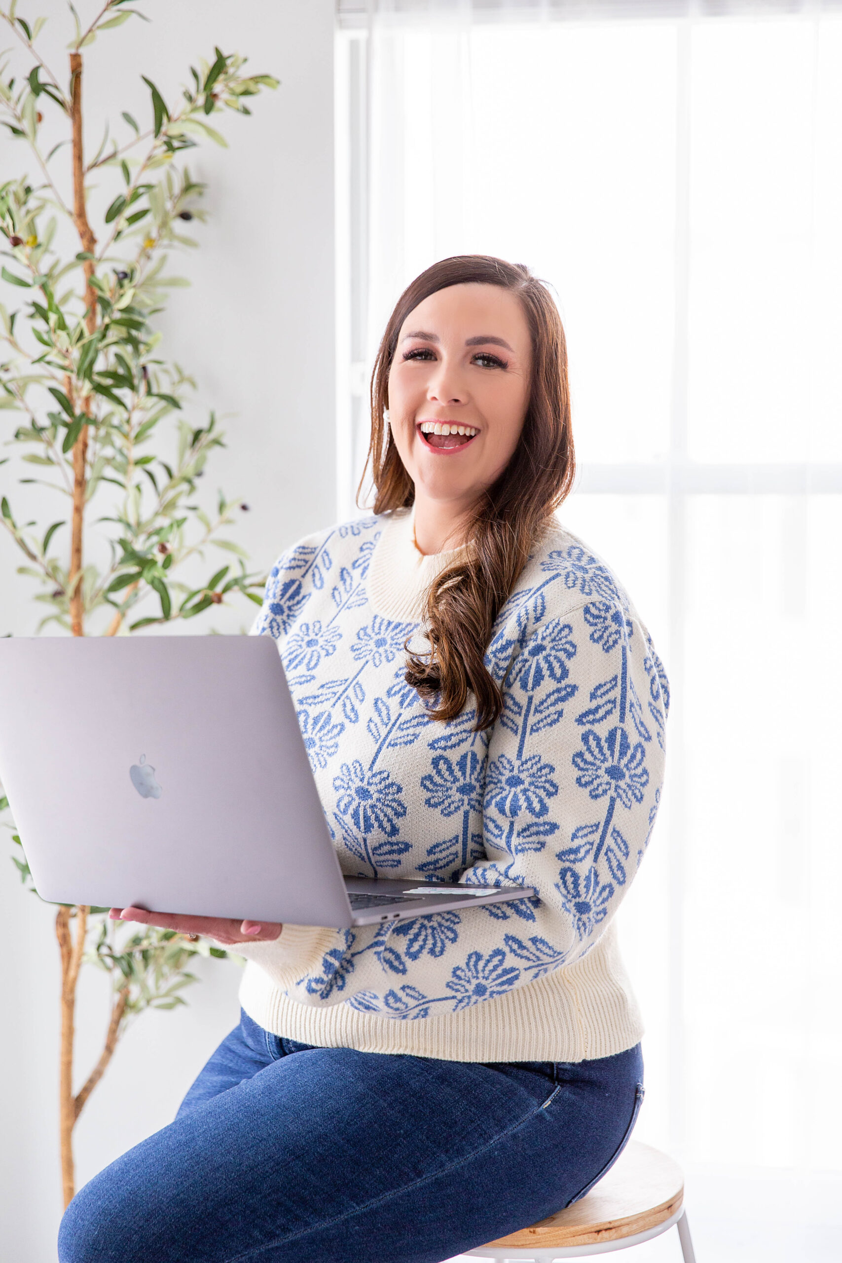 Magan holding her laptop | How a Bundle Helped Grow Our Email Lists | Magan Ward